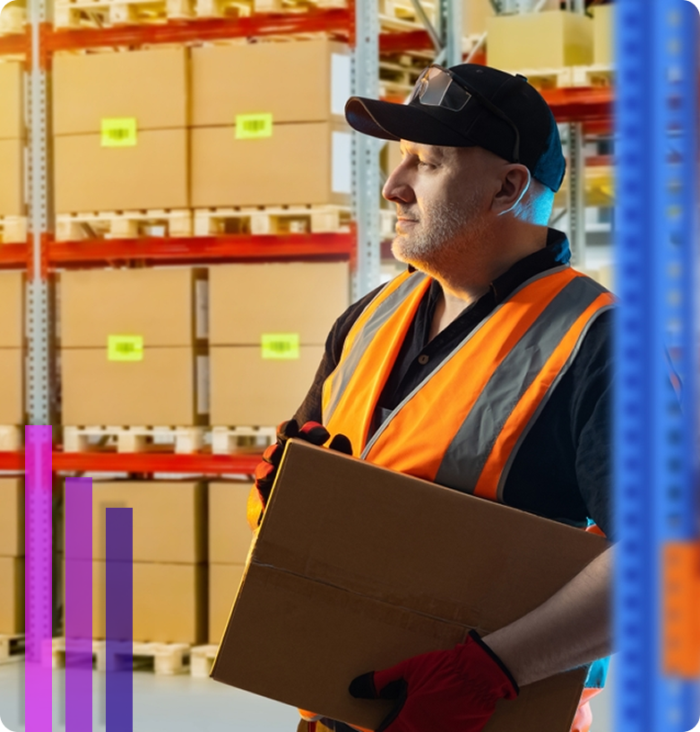 Warehouse worker carrying a box while standing in a storage facility aisle